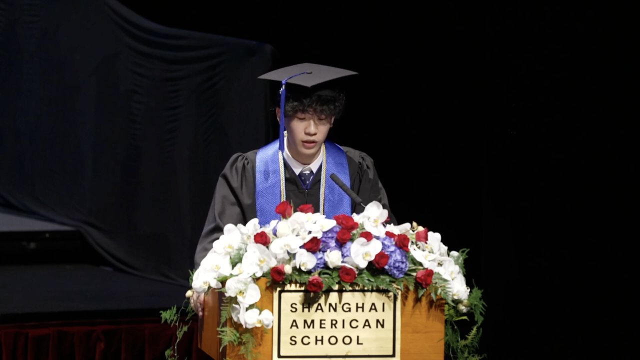 Ethan speaking at the podium during his graduation speech.